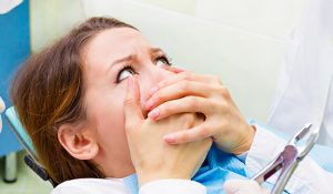 sedation dentistry patient model holding her mouth