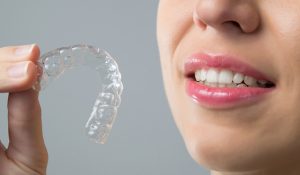 Invisalign patient model looking at her clear aligners
