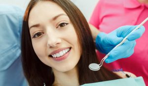 dentist patient model getting her teeth cleaned