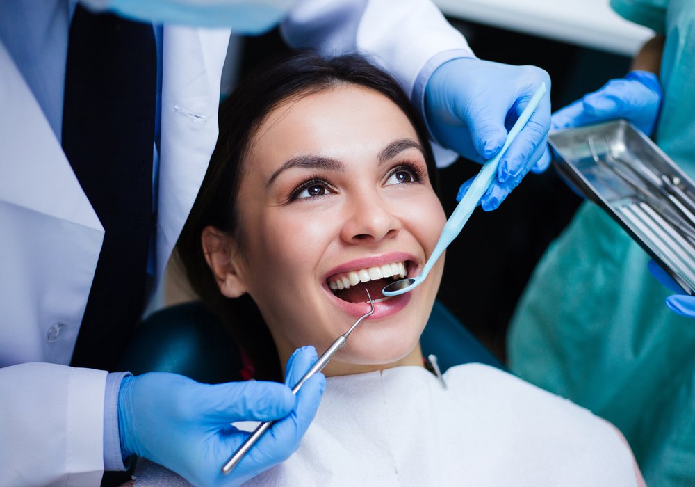 Emergency Tooth Pain patient model receiving dental care in a dental chair