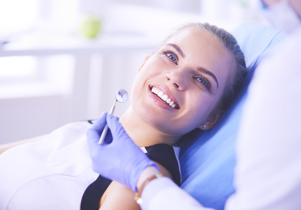 dental veneers patient model in a dental chair smiling