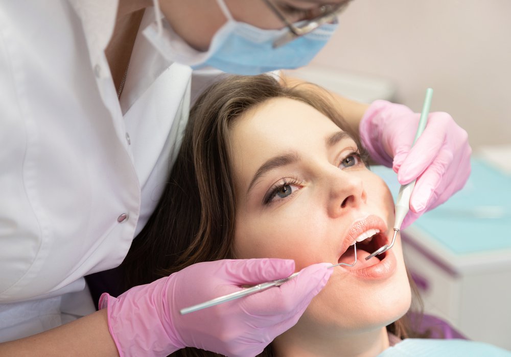 philadelphia periodontics patient model getting her teeth cleaned